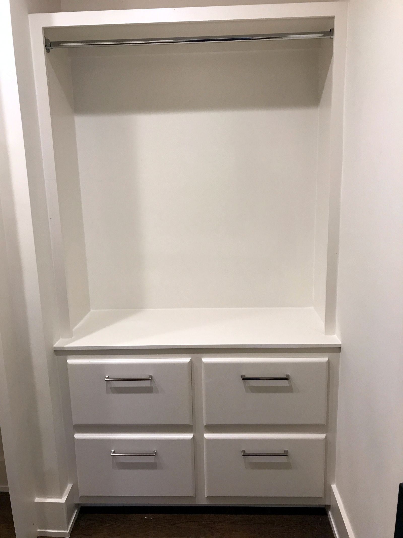 Painted built-in closet unit with four drawers