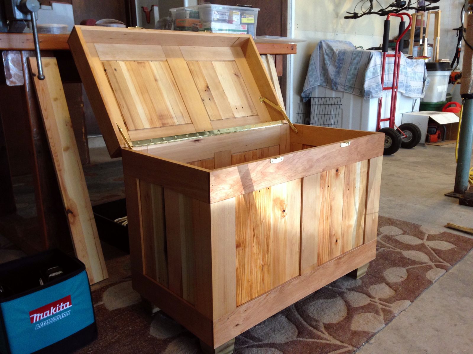 Open storage chest showing the inside of the lid and wood interior